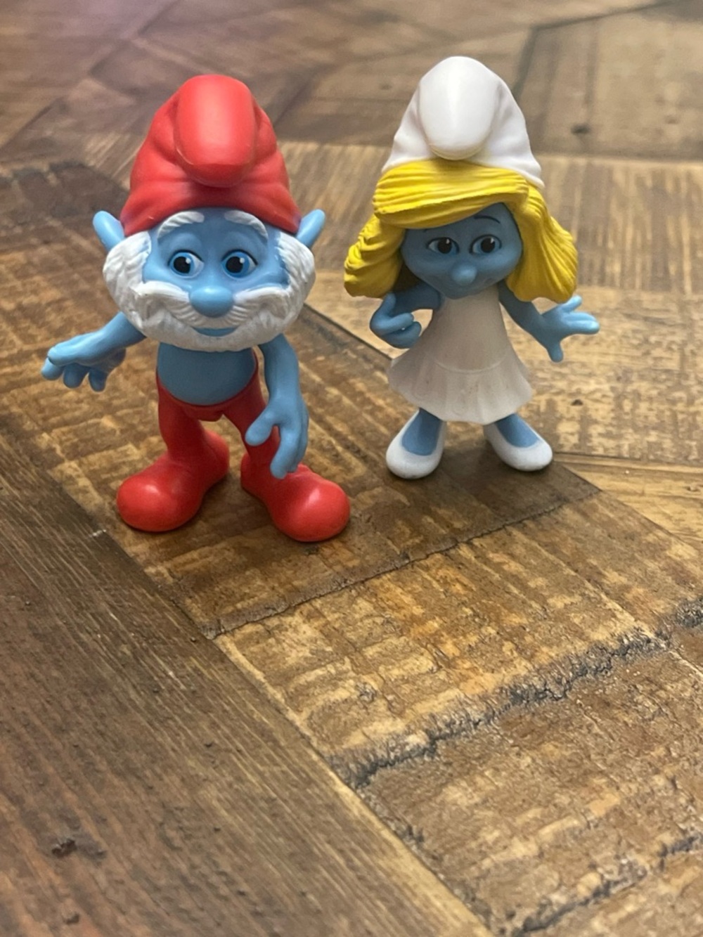 collectible figures of Papa Smurf and Smurfette from The Smurfs Movie